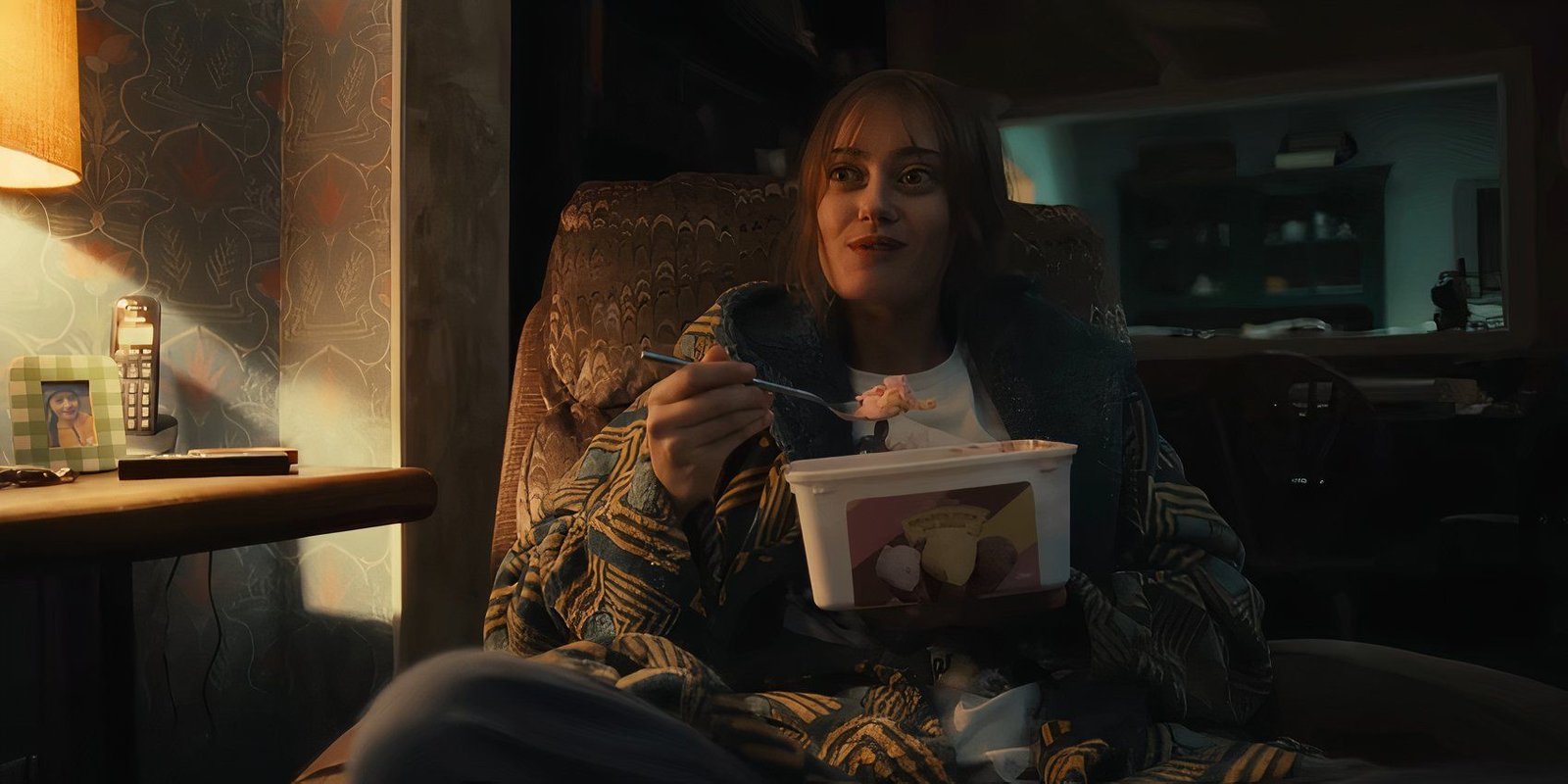 Ella Purnell as Rhiannon Lewis smiling while eating ice cream in Sweetpea