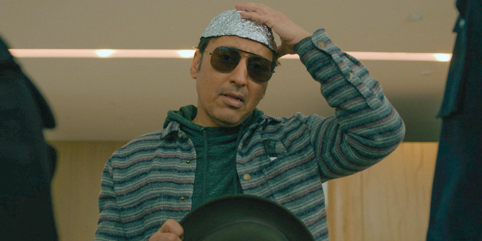 Ben Shakir (Aasif Mandvi) wearing a tin foil hat in Evil Season 4 Episode 9