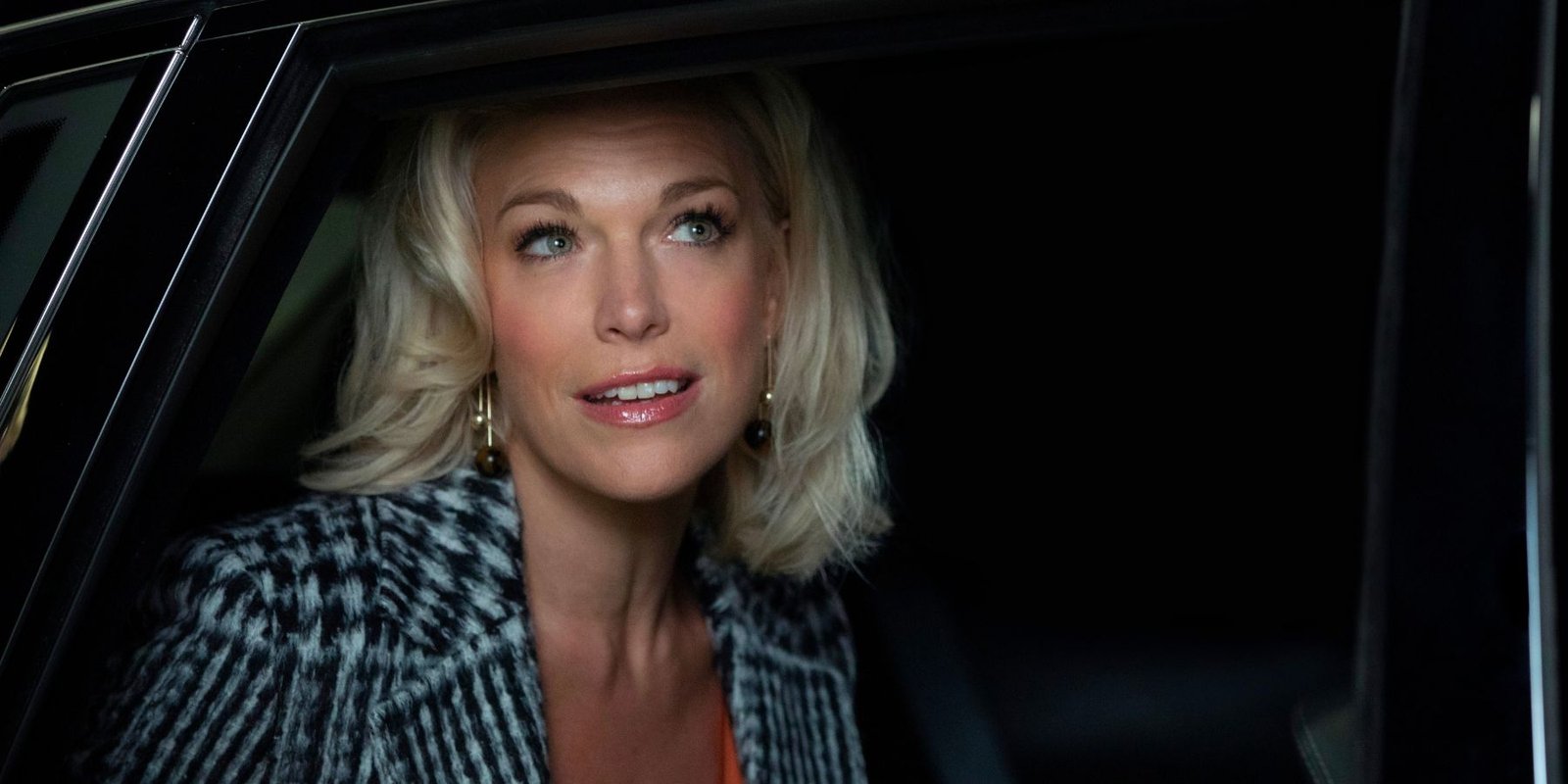 Hannah Waddingham as Rebecca smiling in a car in the Ted Lasso pilot